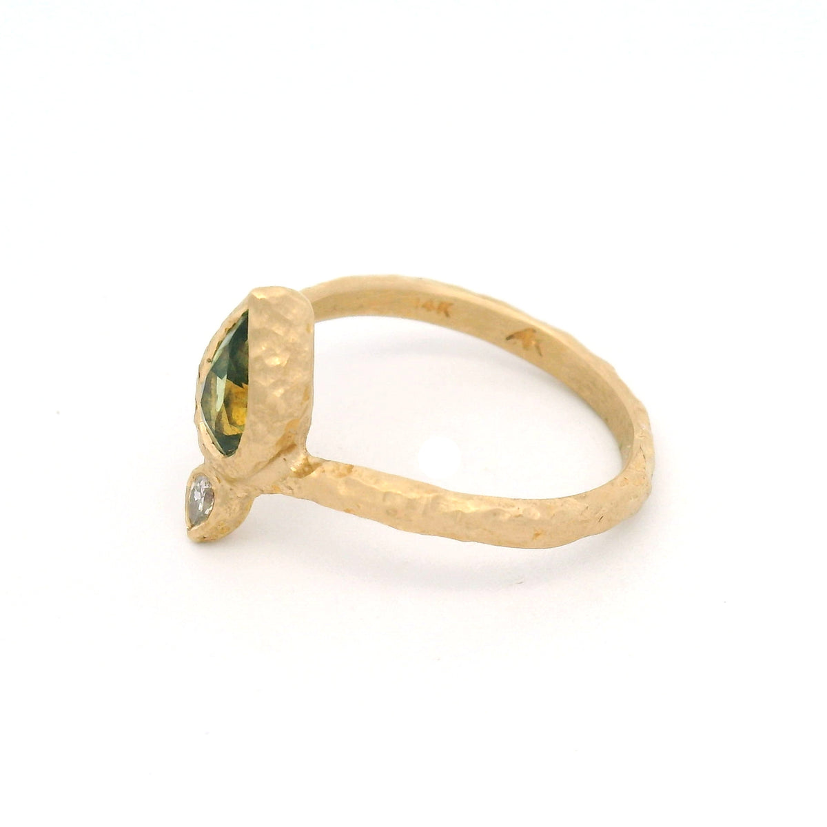 14K yellow gold Moi et Toi engagement ring with bezel-set pear-shaped green sapphire and diamond pointing outward on an organic textured diadem band.