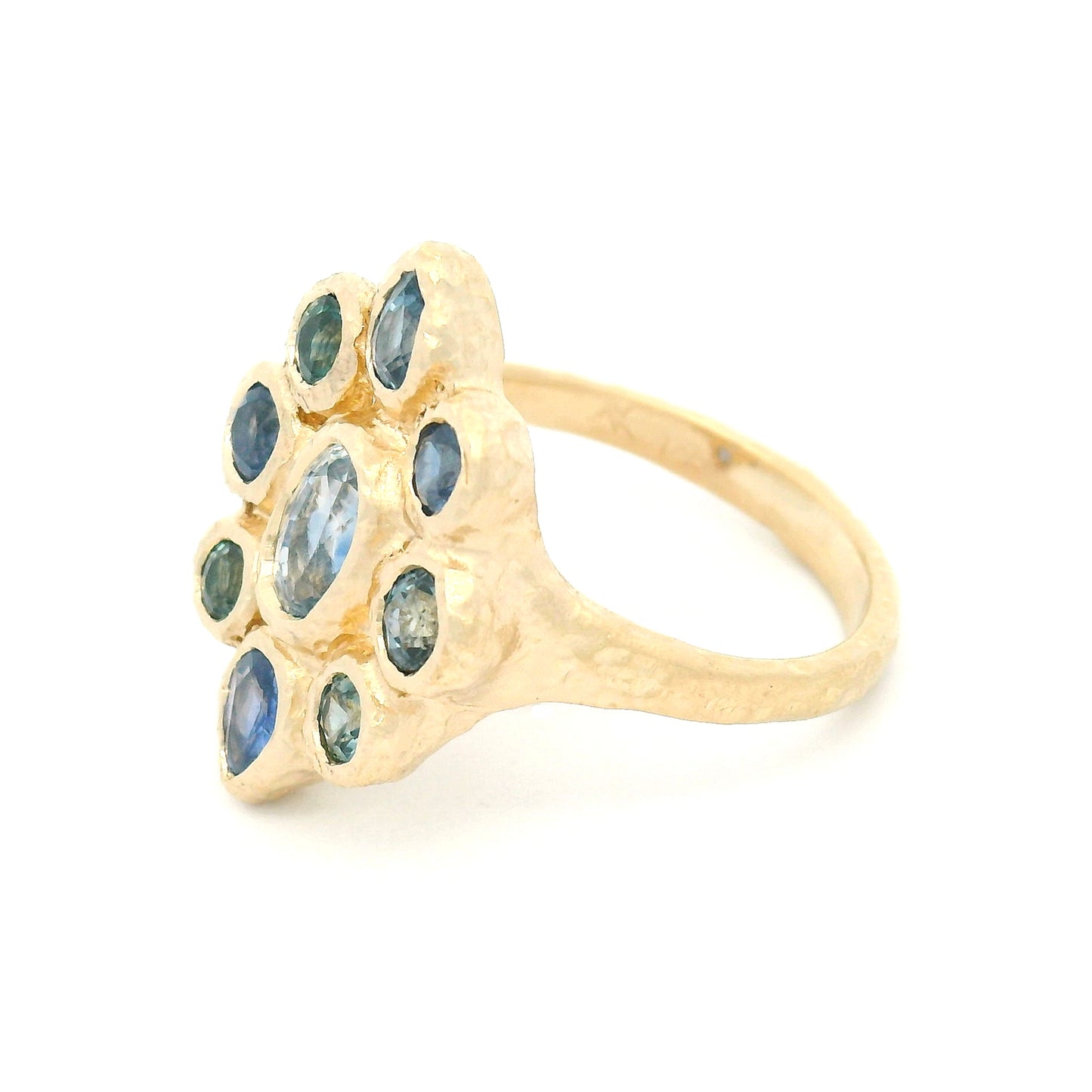 14K yellow gold organic cluster engagement ring with natural 0.66ct oval blue sapphire and 1.72cts pear-shaped and round blue sapphire accents.