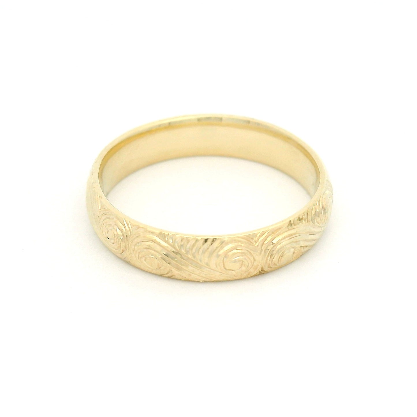 10K yellow gold 4mm soft domed band with hand-engraved ocean wave pattern and textured finish.