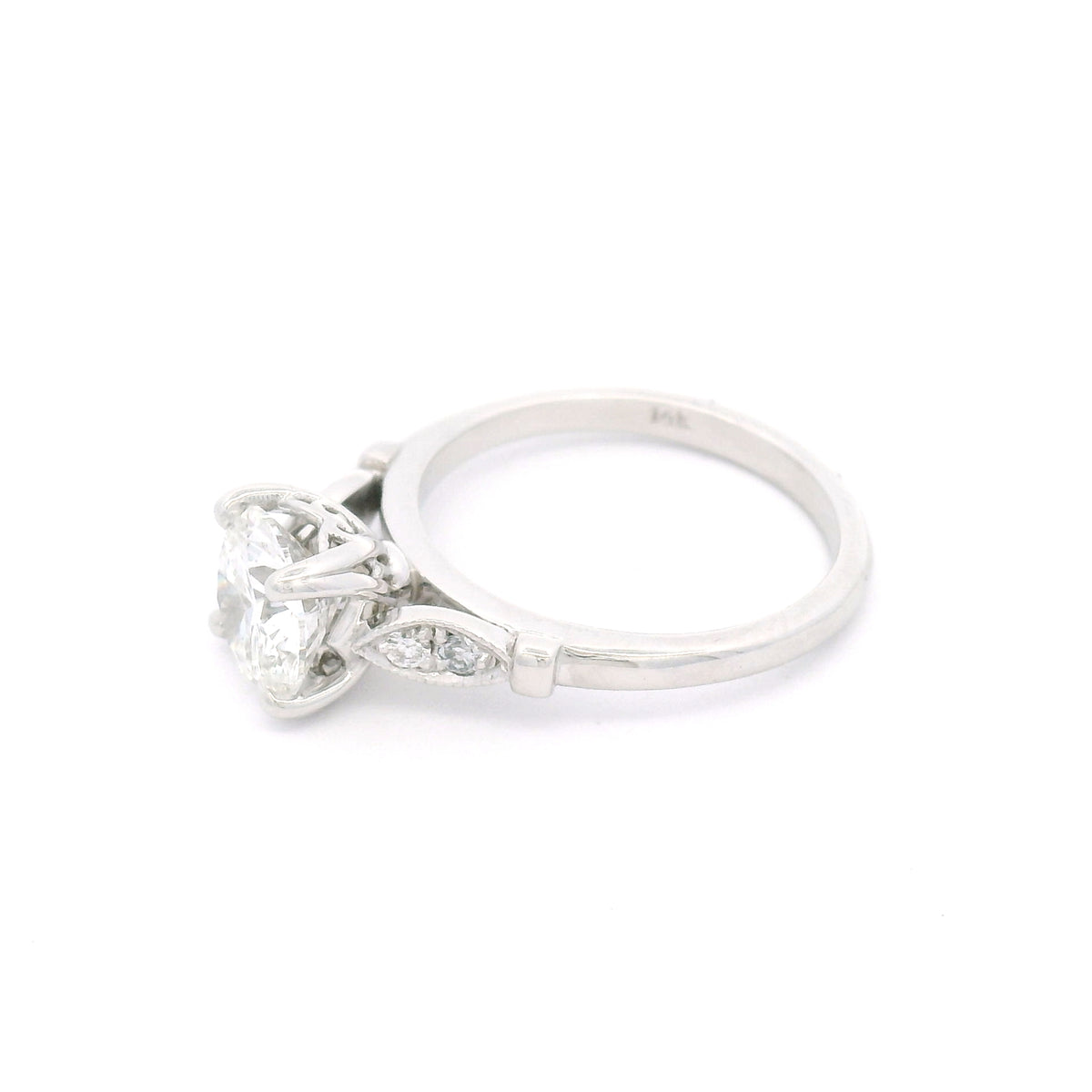 14K white gold engagement ring with a claw-set 1.50ct lab-grown round brilliant-cut diamond and four bead-set lab-grown diamond accents within milgrain-edged leaf motifs.