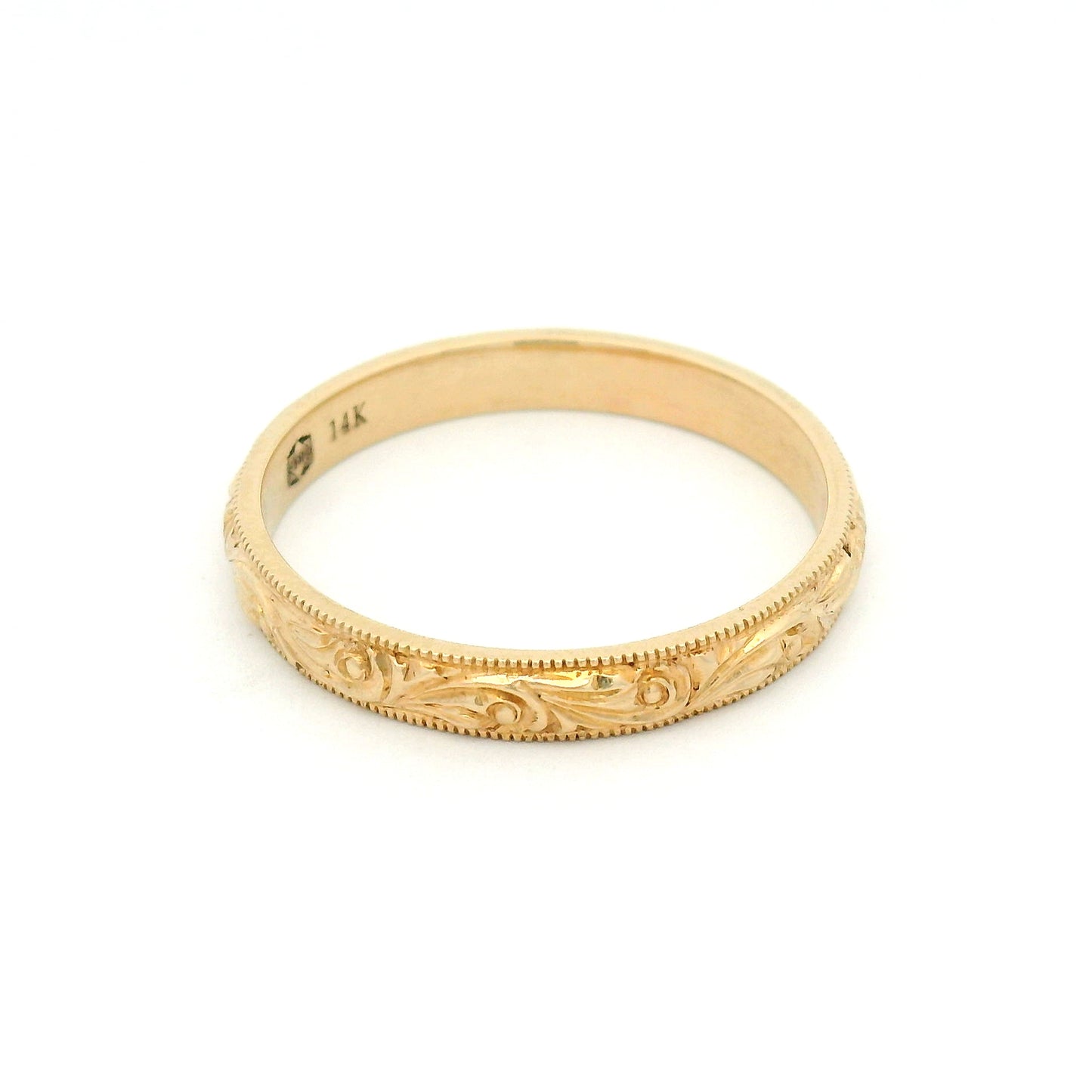 14K yellow gold 3mm wedding band featuring a hand-engraved scroll pattern and fine milgrain edges with vintage-inspired detailing.