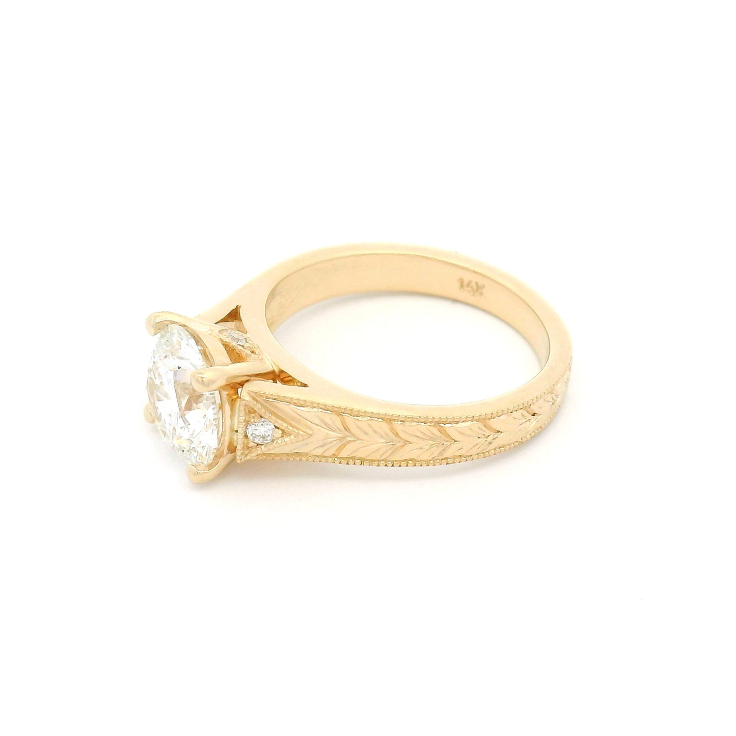 14K yellow gold engagement ring featuring a claw-set 2.05ct lab-grown round brilliant-cut diamond with bead-set diamond accents, hand-engraved wheat pattern and milgrain edges.