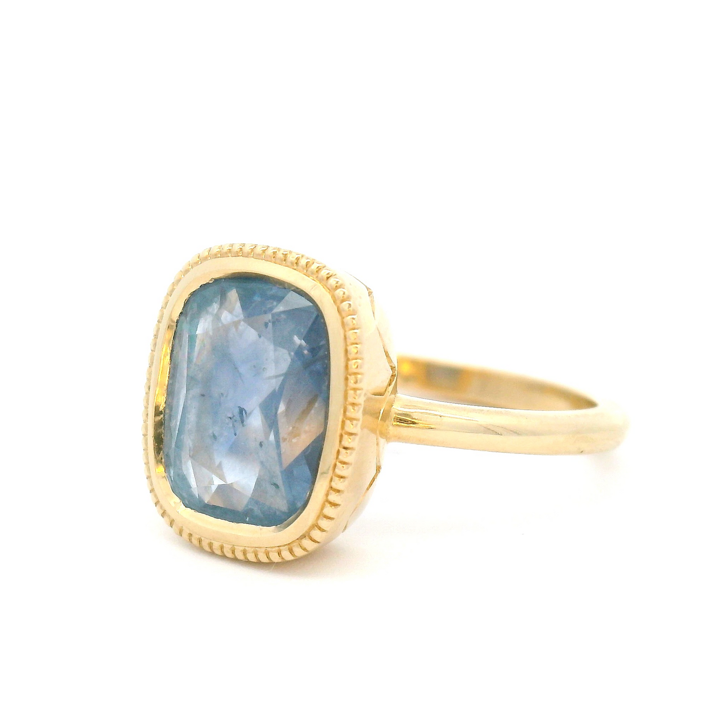 10k Yellow Bezel-Set Solitaire with 3.75ct Cushion-Cut Light Blue Sapphire Accented with Hand-Engraving