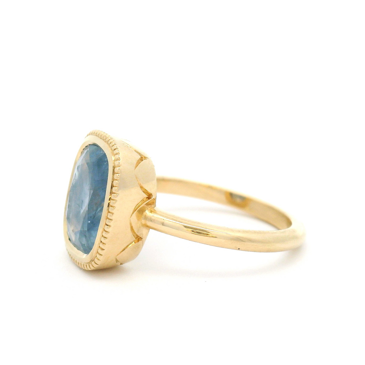 10k Yellow Bezel-Set Solitaire with 3.75ct Cushion-Cut Light Blue Sapphire Accented with Hand-Engraving