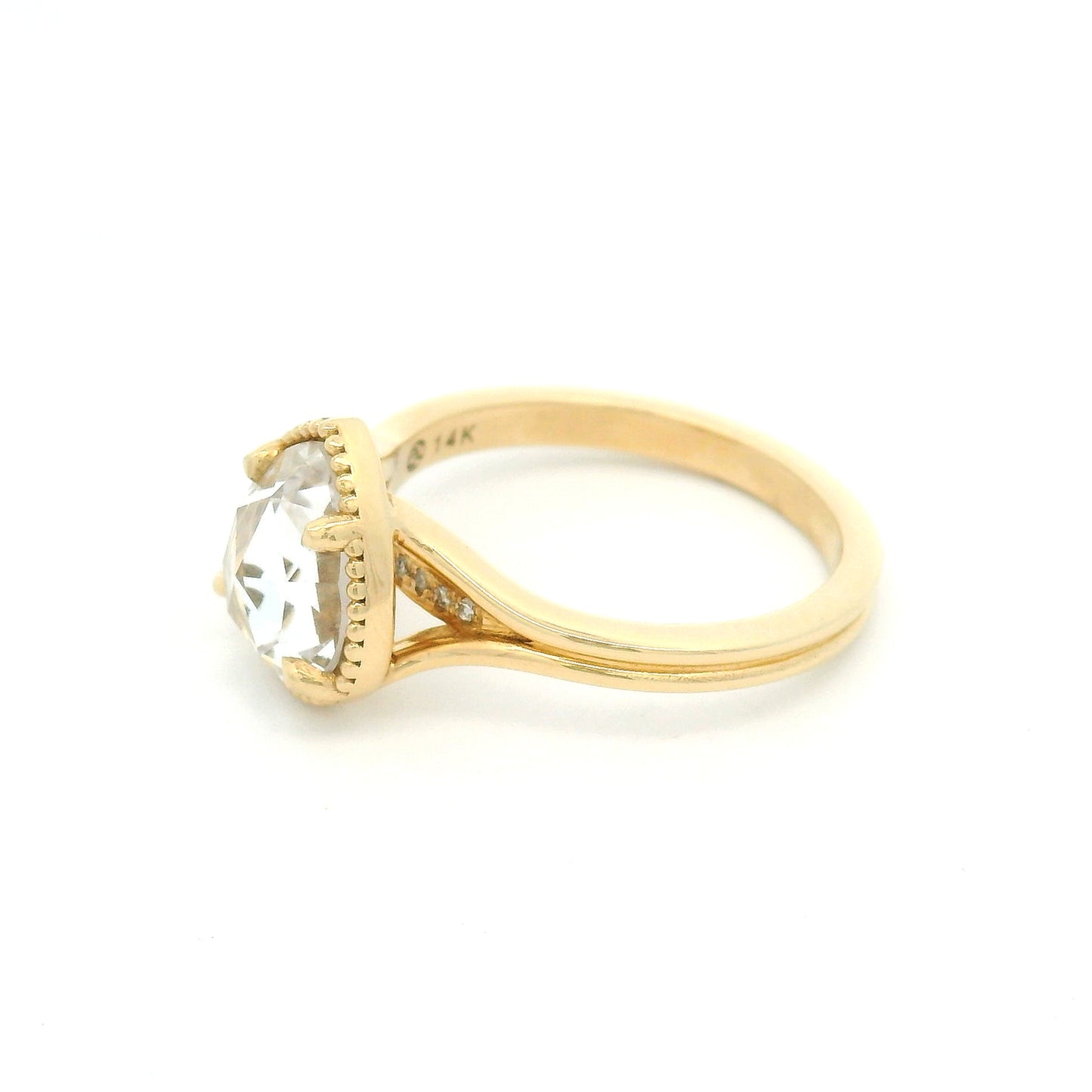 14K yellow gold engagement ring featuring a 2.01ct lab-grown rose-cut pear-shaped white sapphire in a claw setting with milgrain border and hidden bead-set lab-grown diamond accents visible through the centre stone.