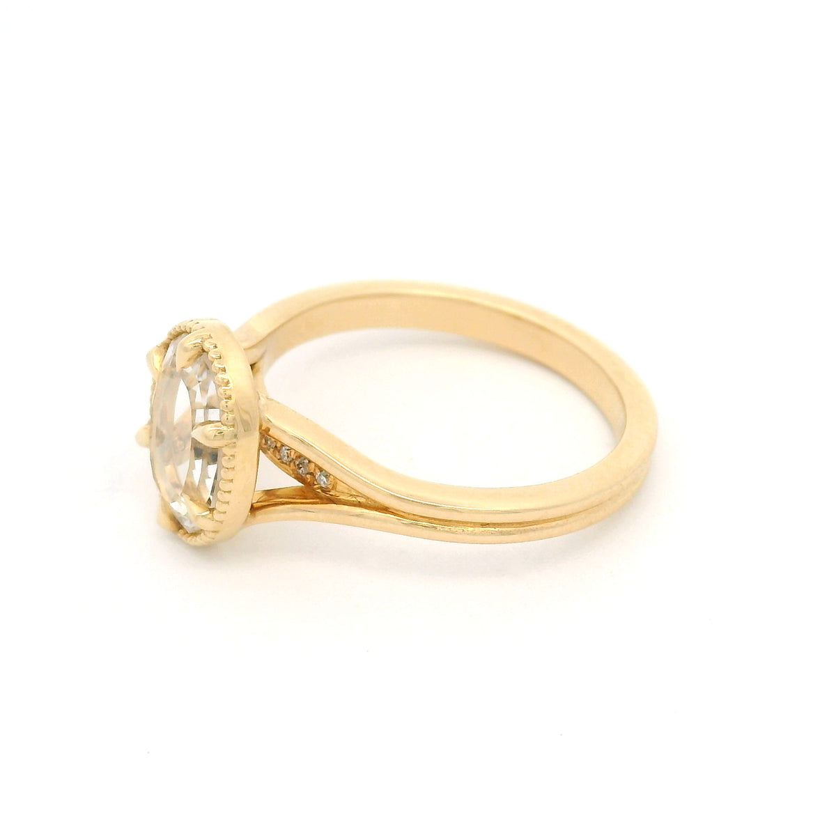 14K yellow gold engagement ring with a 0.82ct lab-grown step-cut hexagon white sapphire, claw setting, milgrain border and hidden diamond accents.