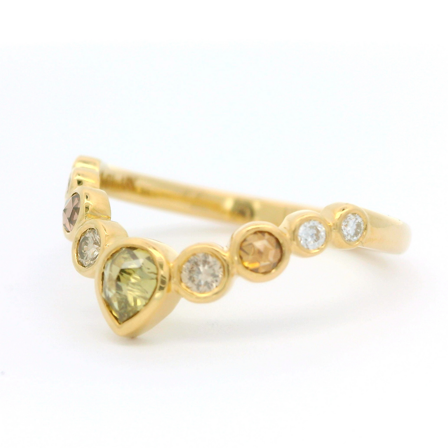 18k yellow contoured ring with nine bezel set diamonds including a stunning green rose cut diamond.
