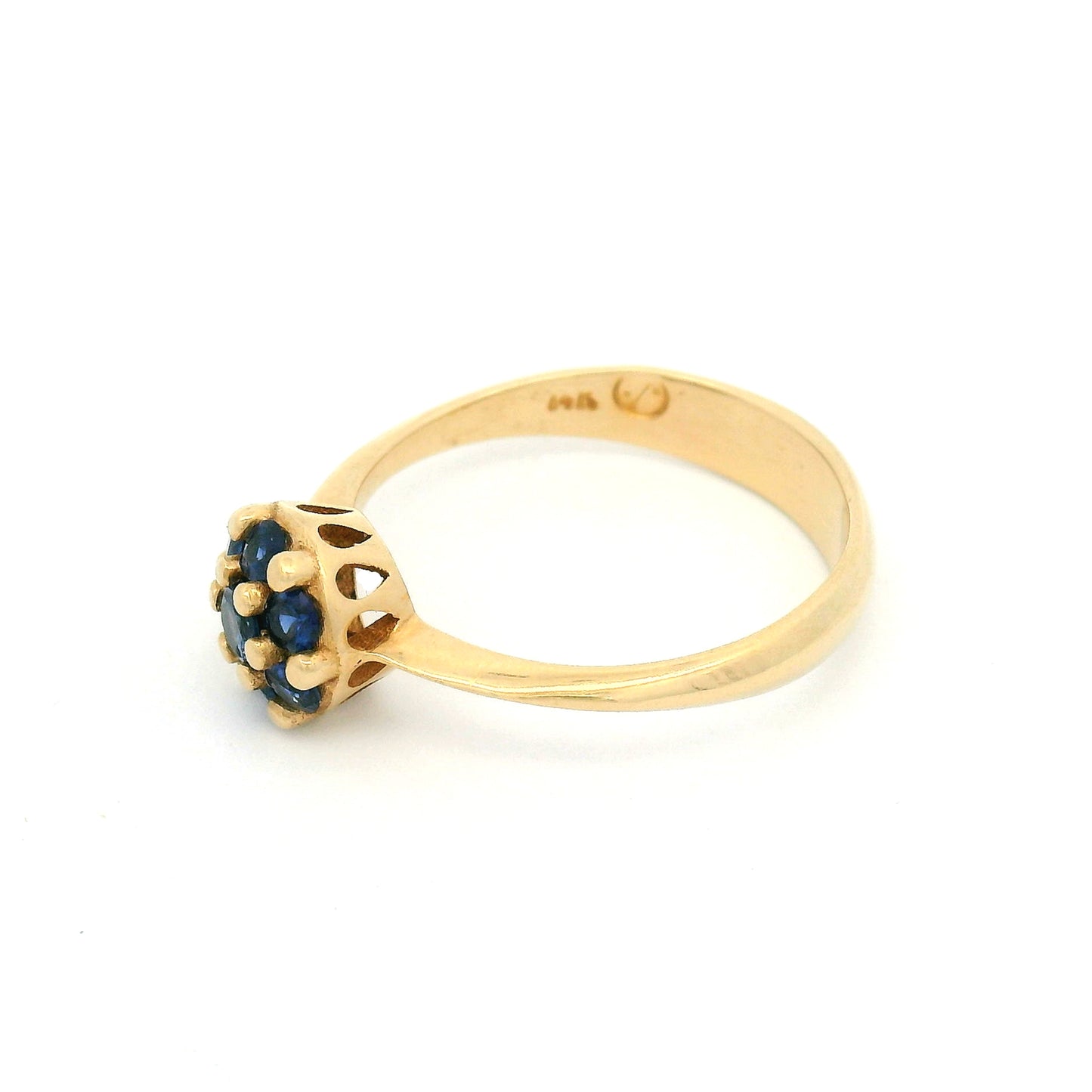 14K yellow gold engagement ring with a cluster of seven claw-set round blue sapphires measuring just over 7mm.