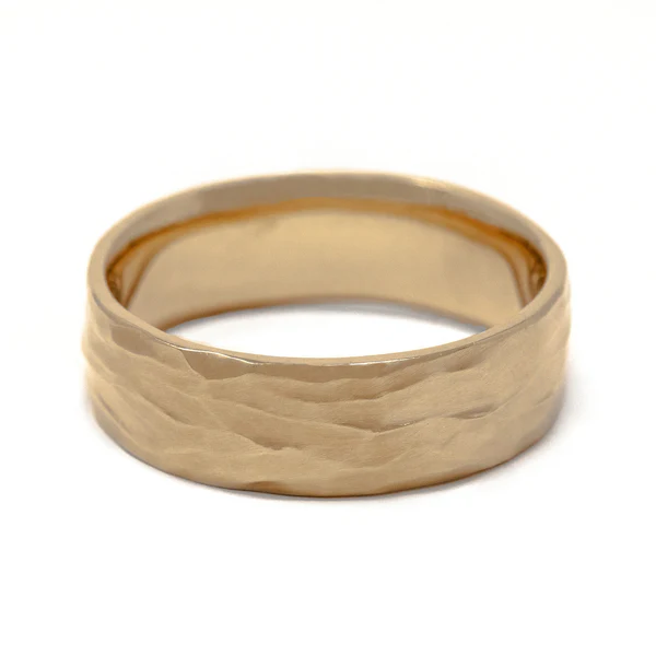 14k Yellow Hand Carved Textured Wedding Band. Shown from a elevated angle.