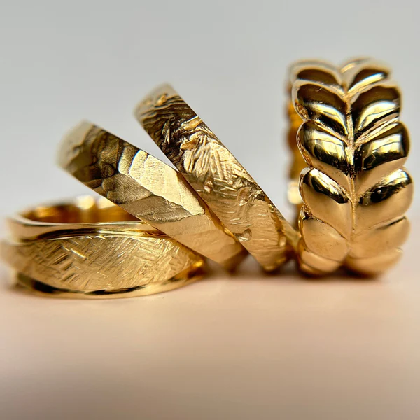 14k Yellow Gold Band Hand Carved with Textured Ribbon. Grouped with 3 other bands.