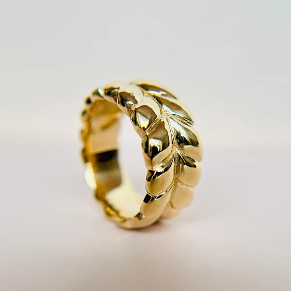 14k Yellow Gold Band Hand Carved with Braided Design. On it's edge.