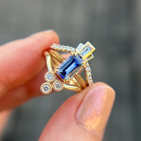14k yellow gold tapered diamond centre contour band engagement ring. Shown stacked with a solitaire and contrasting contoured band.