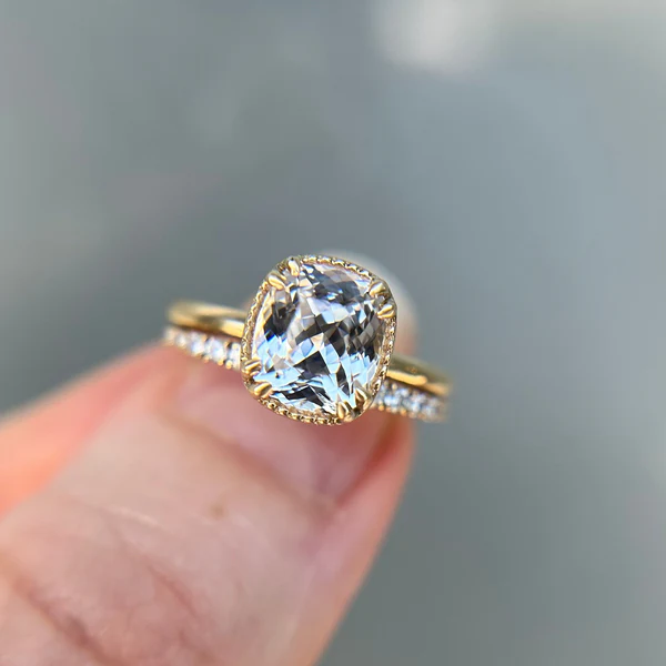 2.68ct Icy Sapphire set in hand crafted 14K yellow gold. Shown with a diamond wedding band.