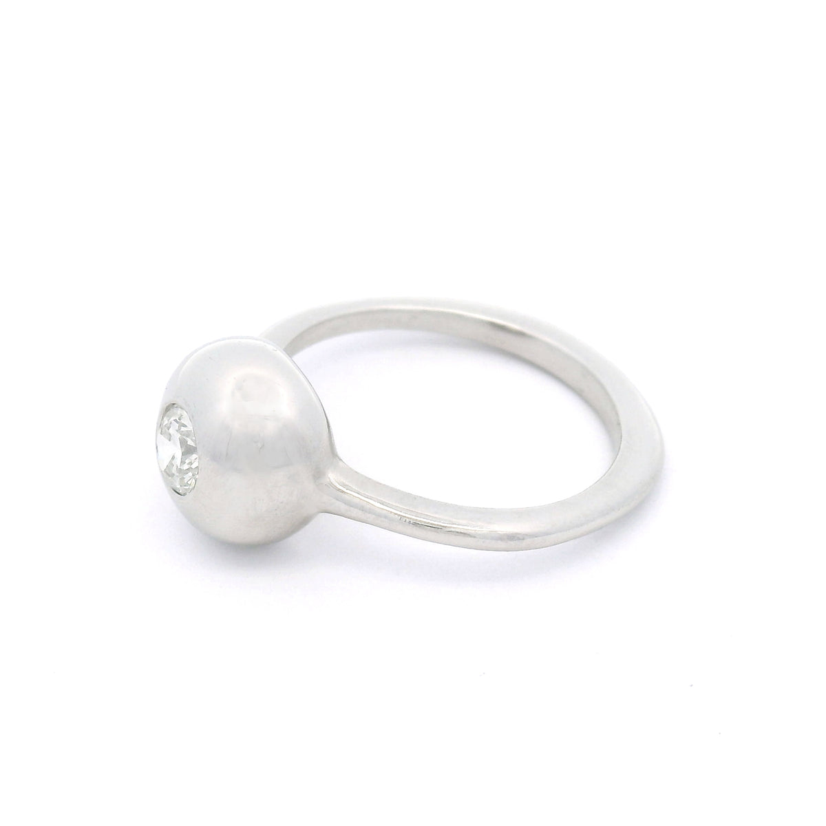 Platinum bezel-set solitaire ring with a natural 0.30ct round brilliant-cut diamond, I1 clarity, K colour, rounded dome and 1.5mm band.