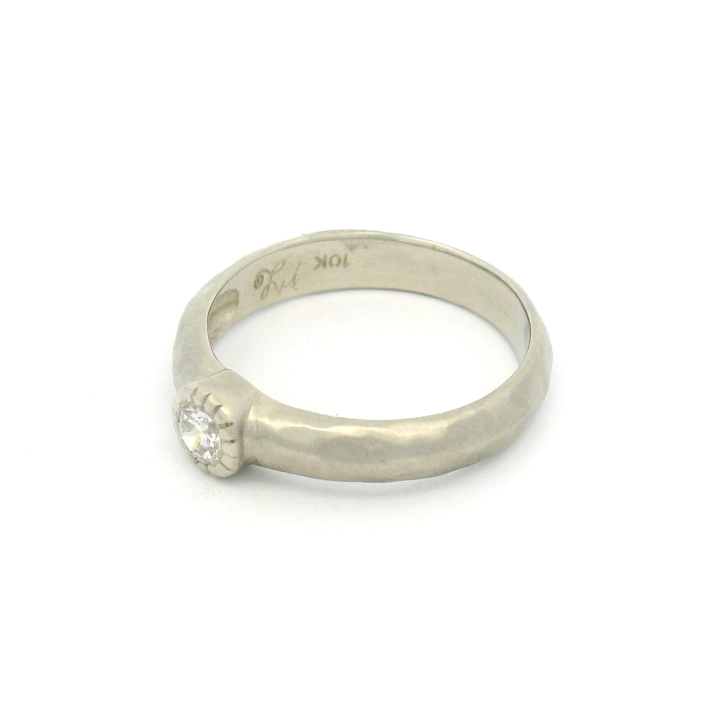 10K white gold organic sculpted solitaire ring with bezel-set 0.18ct round brilliant-cut diamond and milgrain-detailed bezel.