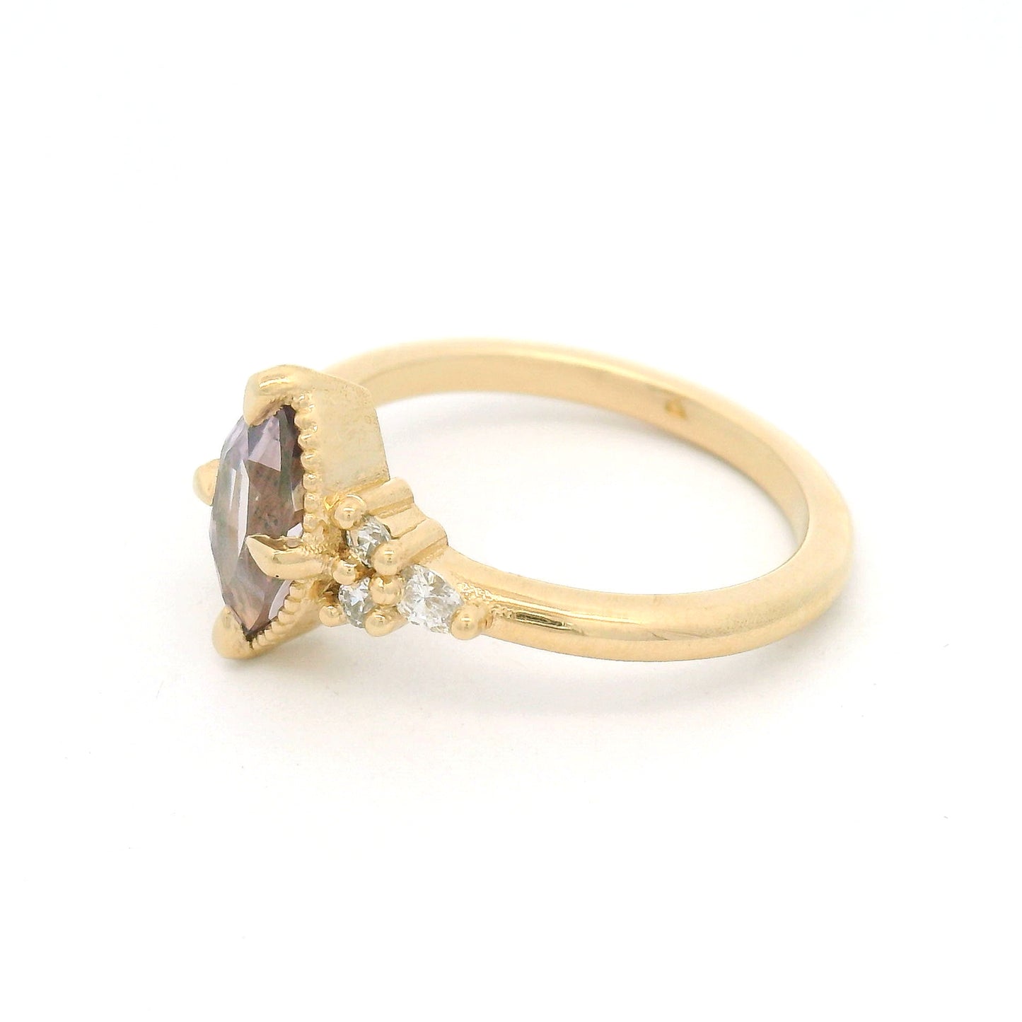 14K yellow gold engagement ring featuring a claw-set natural 1.20ct pink marquise sapphire with four round brilliant-cut and two pear-shaped lab-grown diamond accents totalling 0.19cts.