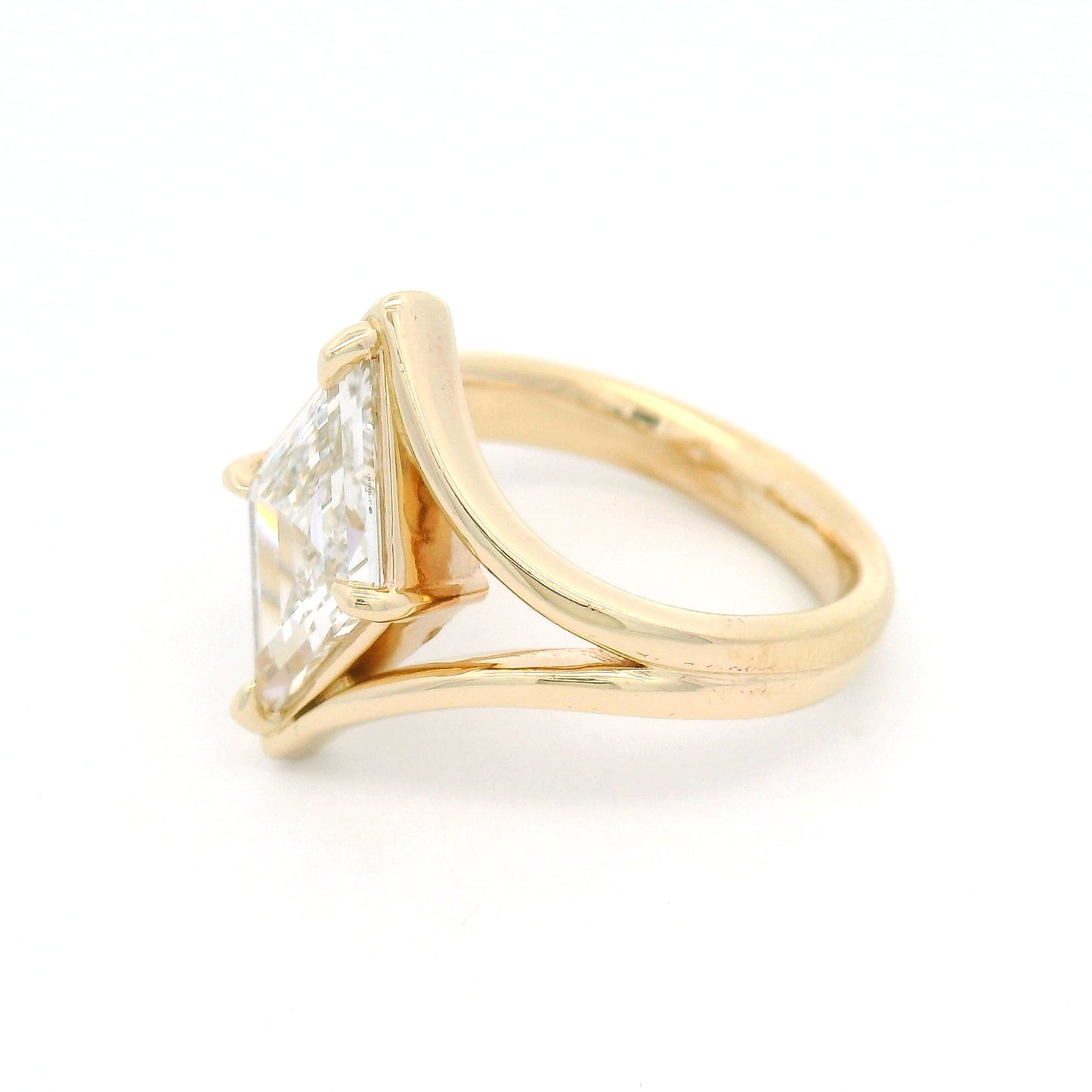 14K yellow gold solitaire engagement ring with a claw-set 1.80ct lozenge-shaped step-cut lab-grown diamond and sculptural split band.