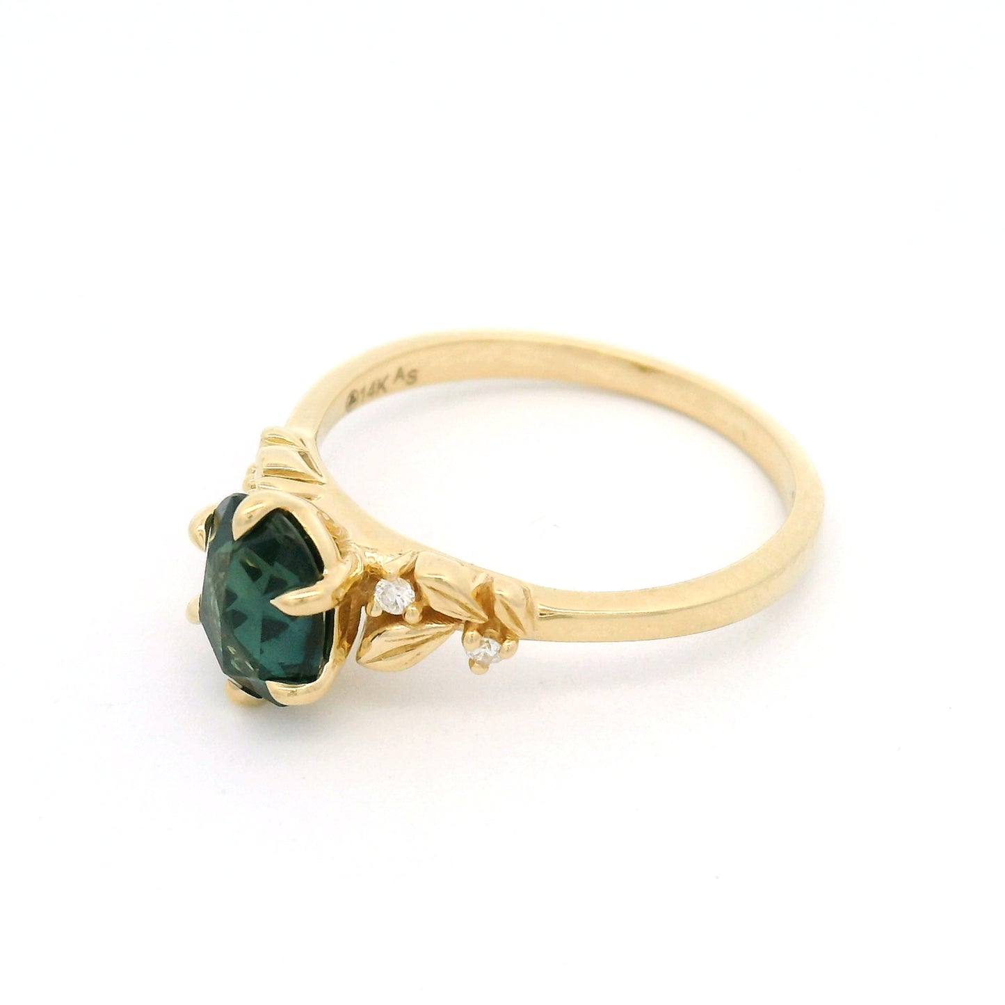 14K yellow gold engagement ring featuring a 1.1ct oval rose-cut green sapphire with diamond accents and sculpted leaf detailing on a delicate band.