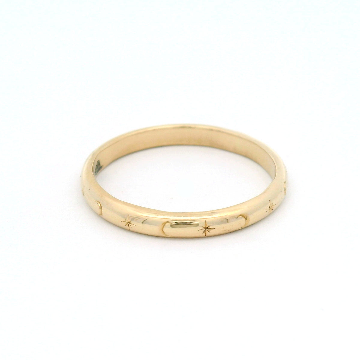 10K yellow gold 2.5mm soft dome band hand-engraved with alternating star and crescent moon motifs.