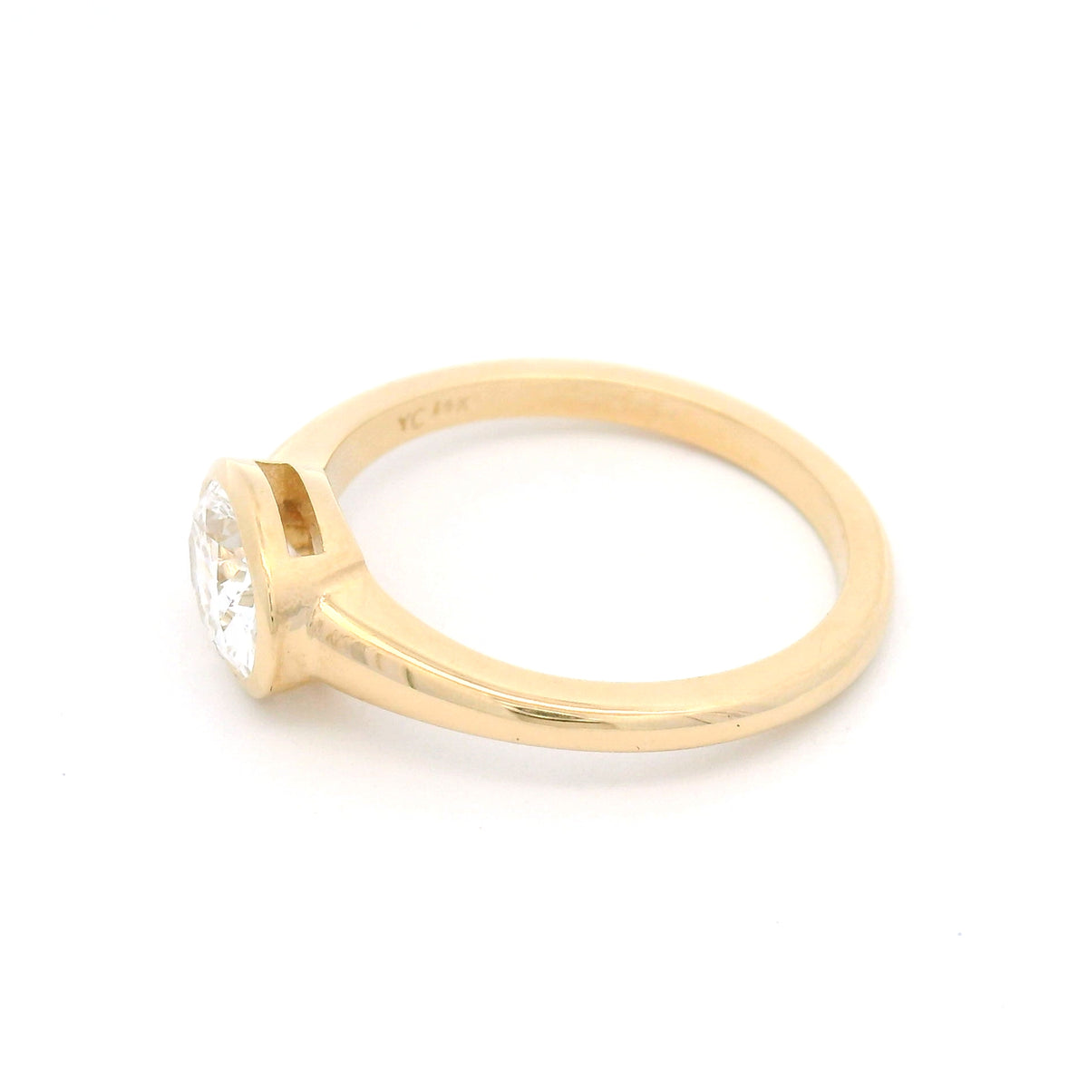 14K yellow gold east-west oval bezel solitaire ring with a 1.0ct lab-grown diamond, tapering shoulders and low-profile signet-inspired design.