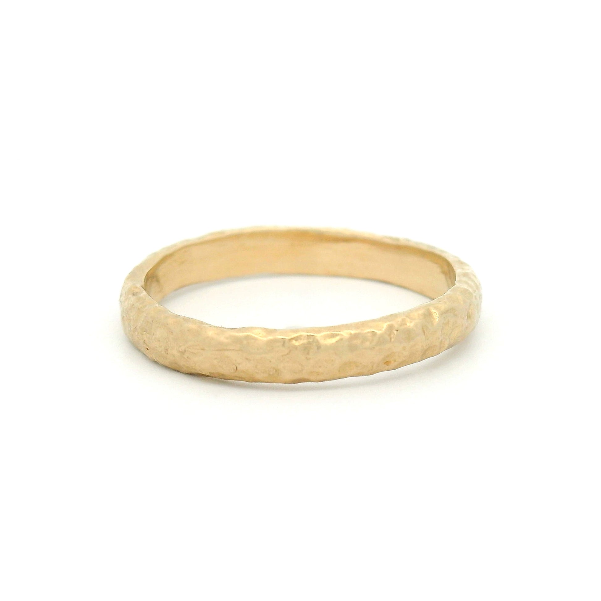 14K yellow gold 2.9mm wedding band featuring an organic seashore-inspired texture with a handcrafted finish.