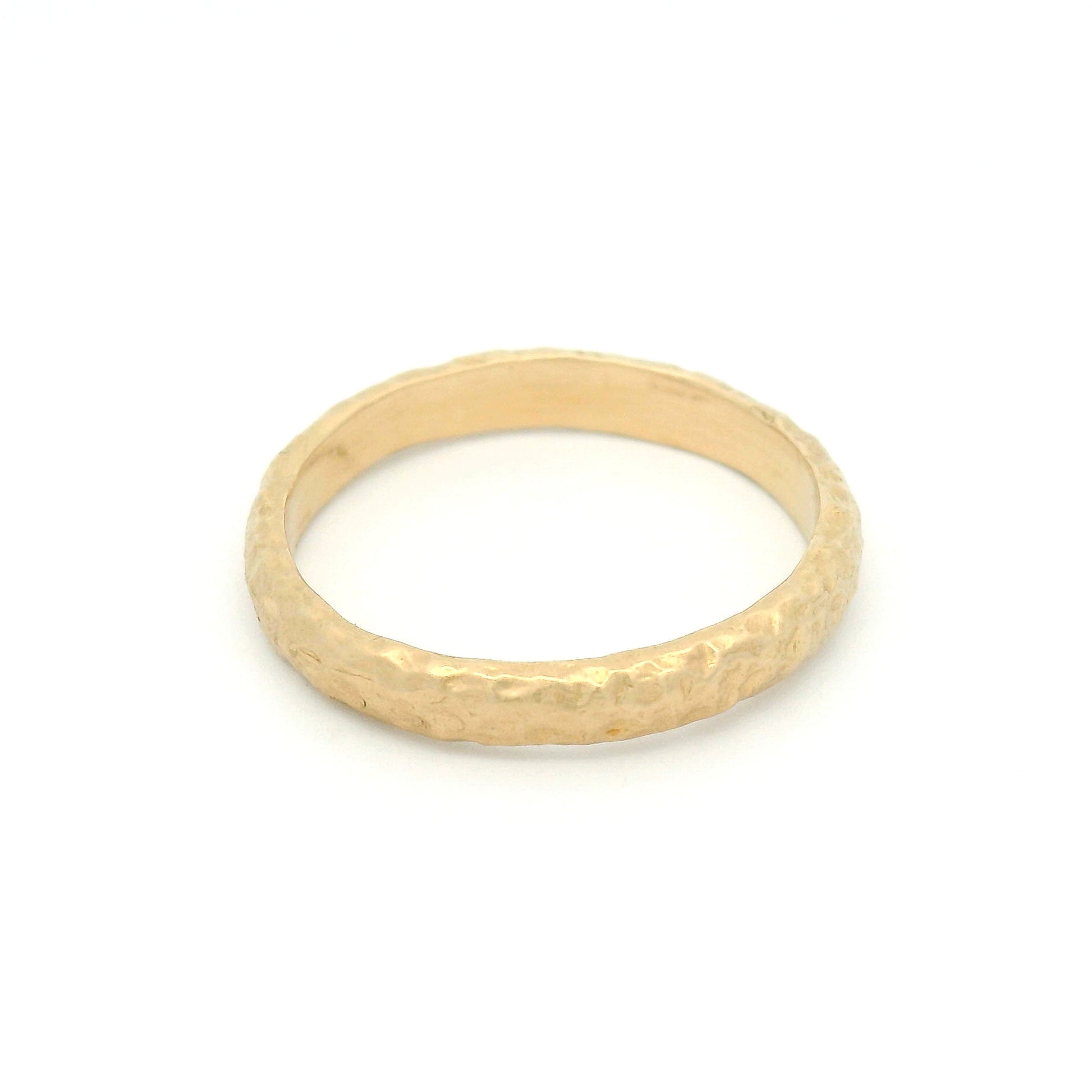 14K yellow gold 2.9mm wedding band featuring an organic seashore-inspired texture with a handcrafted finish.