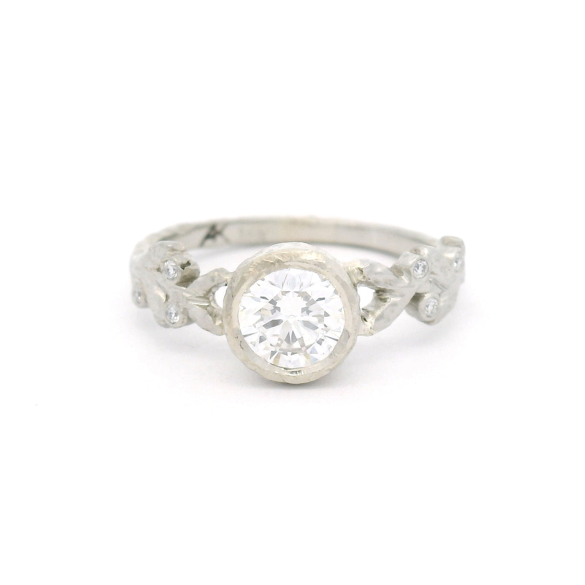 14K white gold textured leaf engagement ring with a 0.74ct lab-grown round brilliant-cut diamond and six bead-set lab-grown diamonds among the leaves.