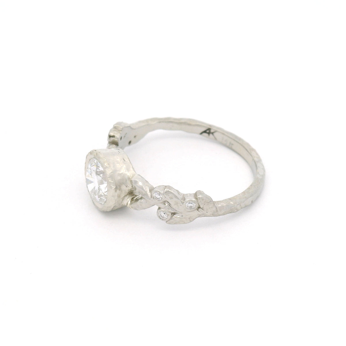 14K white gold textured leaf engagement ring with a 0.74ct lab-grown round brilliant-cut diamond and six bead-set lab-grown diamonds among the leaves.