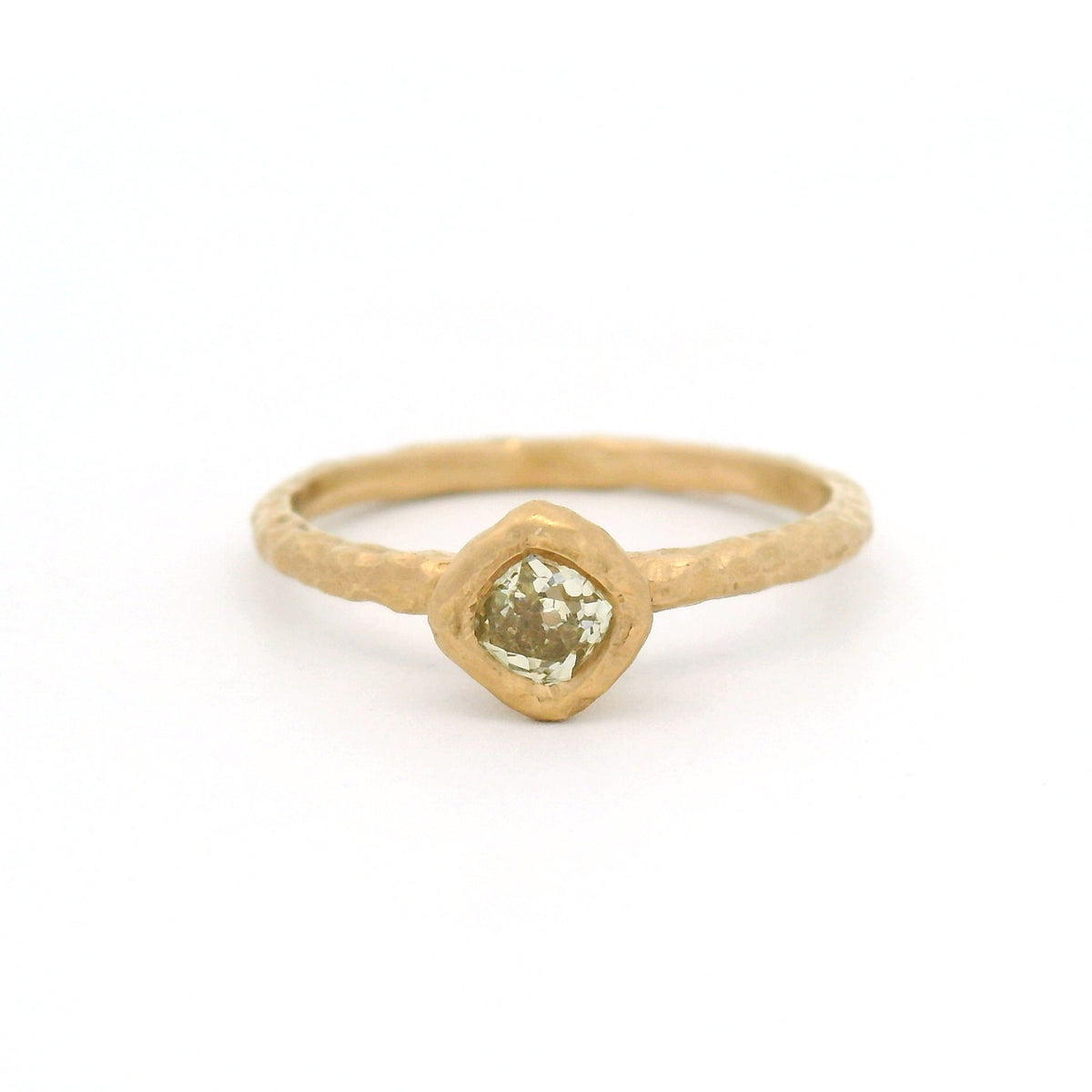 14K yellow gold organic-textured solitaire ring with a bezel-set natural 0.28ct Old European-cut diamond in a slim gold band.