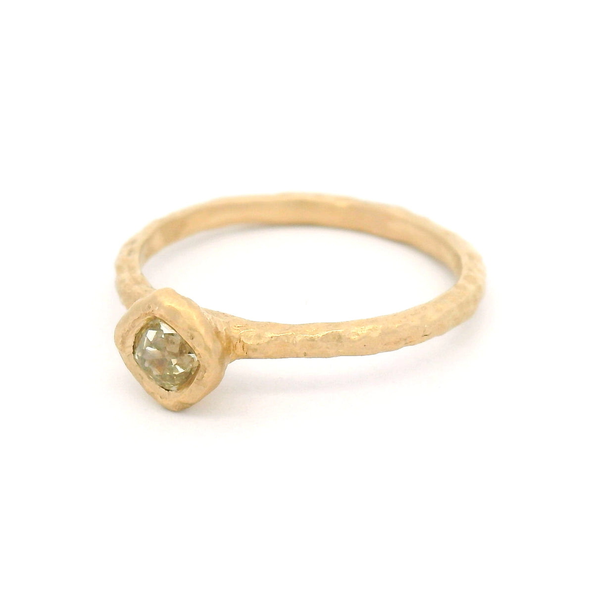 14K yellow gold organic-textured solitaire ring with a bezel-set natural 0.28ct Old European-cut diamond in a slim gold band.