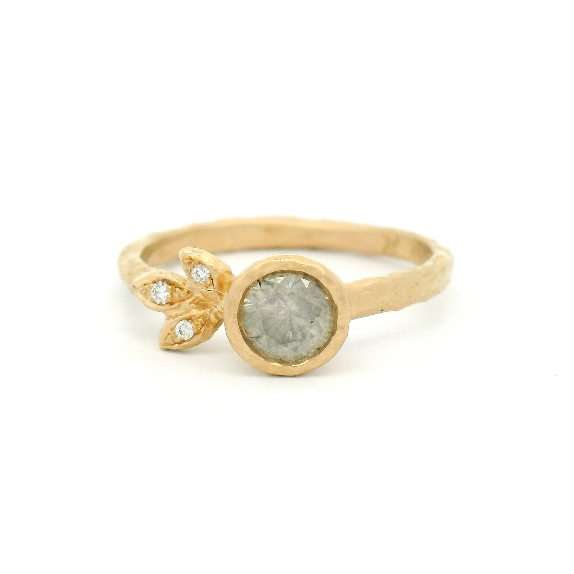 14K yellow gold organic engagement ring featuring a bezel-set 0.51ct icy grey round brilliant diamond and three natural diamond accents set in sculpted leaves.