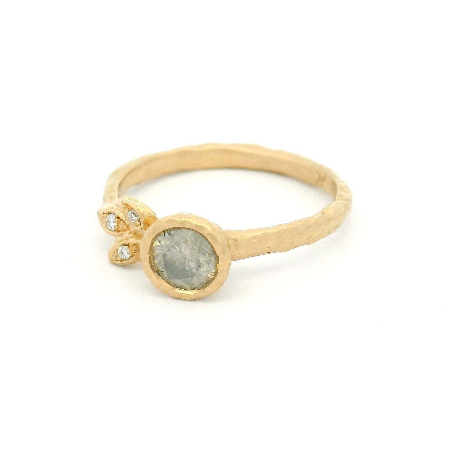 14K yellow gold organic engagement ring featuring a bezel-set 0.51ct icy grey round brilliant diamond and three natural diamond accents set in sculpted leaves.