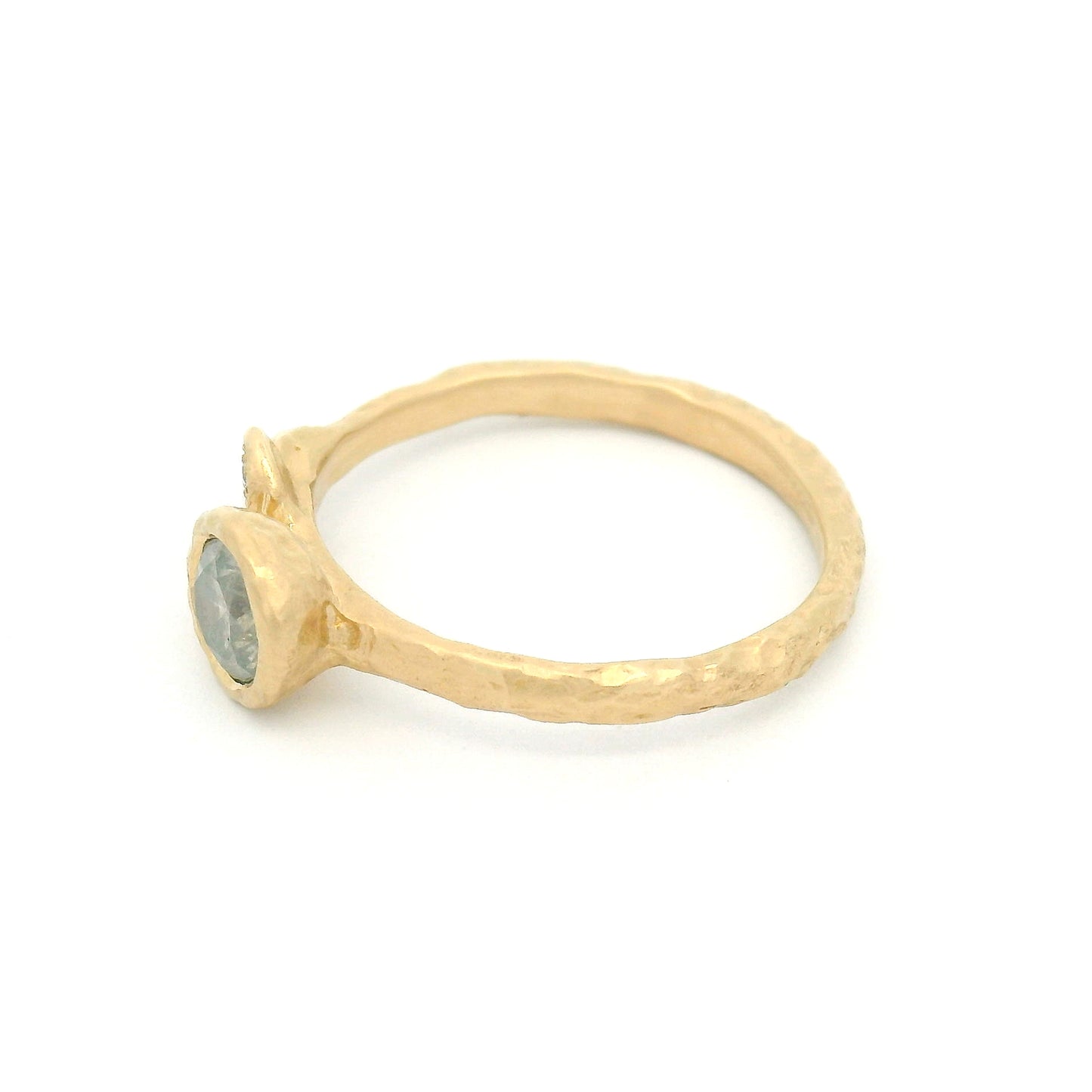 14K yellow gold organic engagement ring featuring a bezel-set 0.51ct icy grey round brilliant diamond and three natural diamond accents set in sculpted leaves.