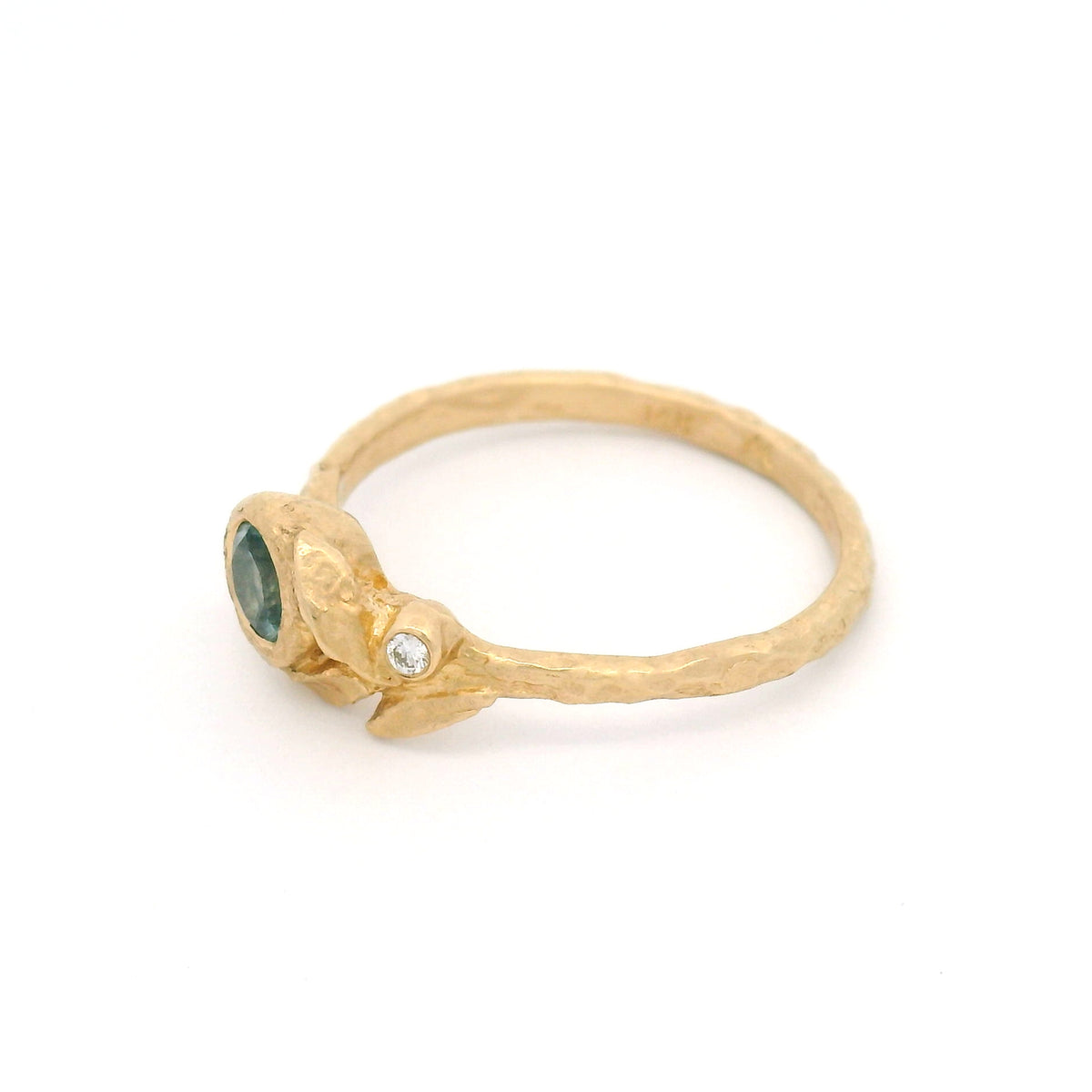 14K yellow gold textured asymmetric engagement ring with a 0.41ct round light-blue sapphire and a diamond accent nestled among three sculpted leaves.