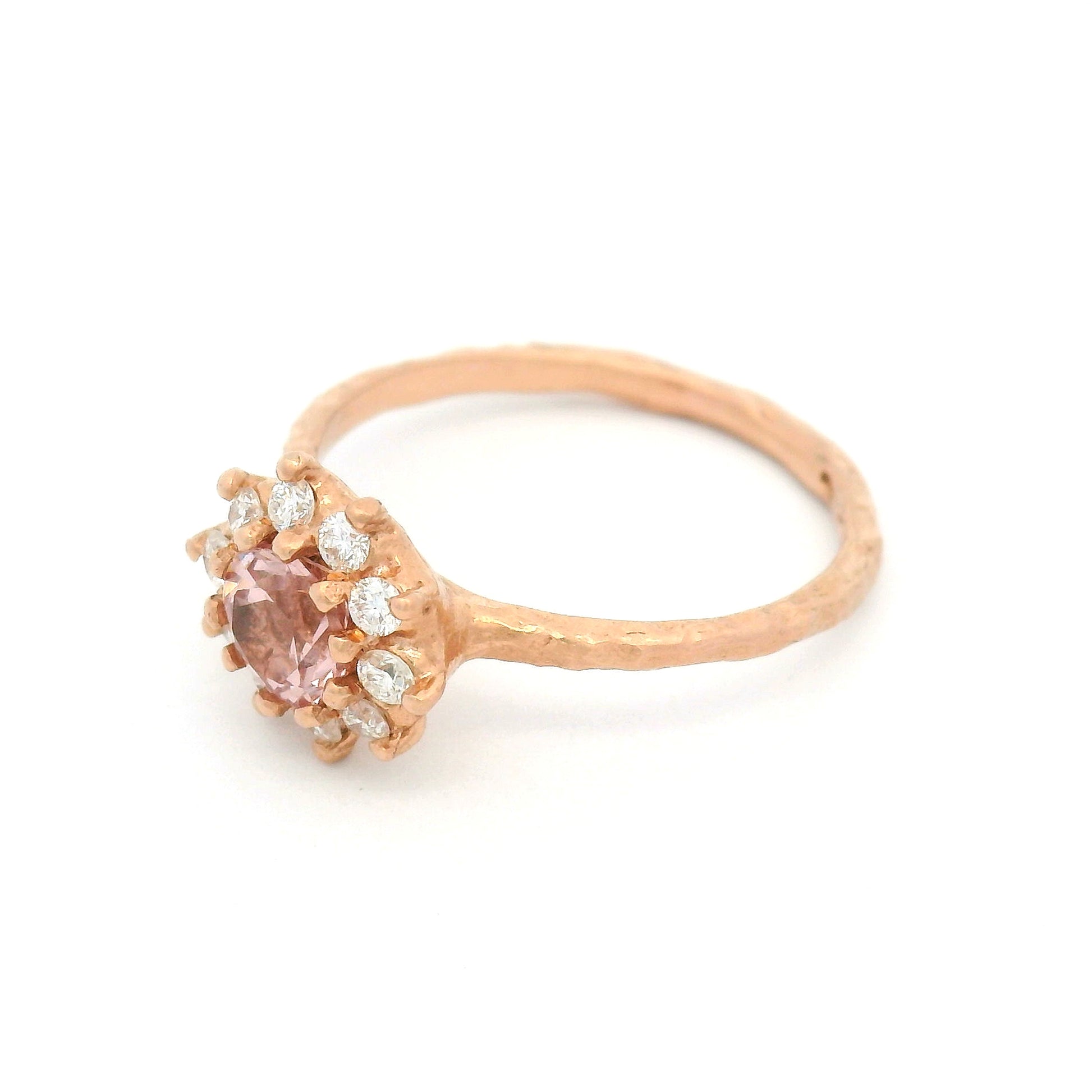10K rose gold organic textured engagement ring with natural 0.62ct round Tanzanian Malaya garnet and halo of ten natural diamonds totalling 0.21cts.