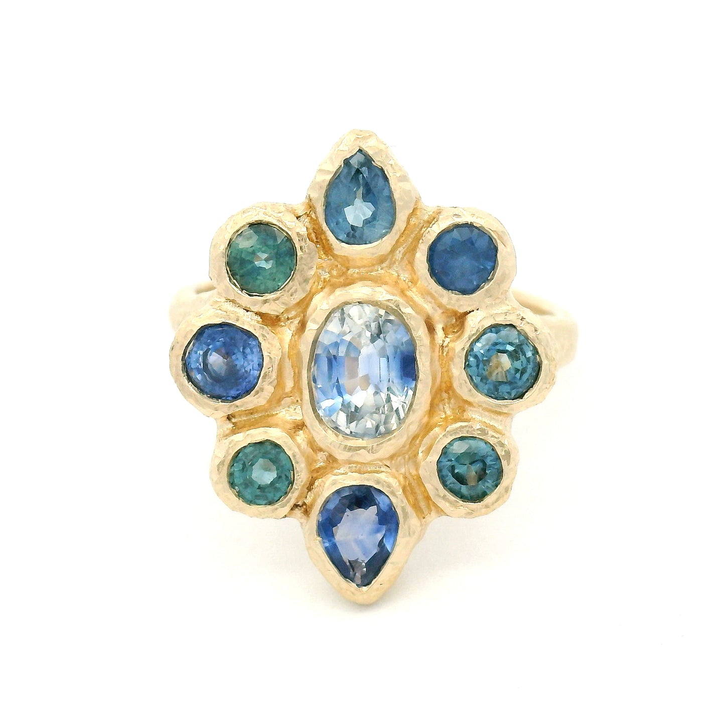 14K yellow gold organic cluster engagement ring with natural 0.66ct oval blue sapphire and 1.72cts pear-shaped and round blue sapphire accents.
