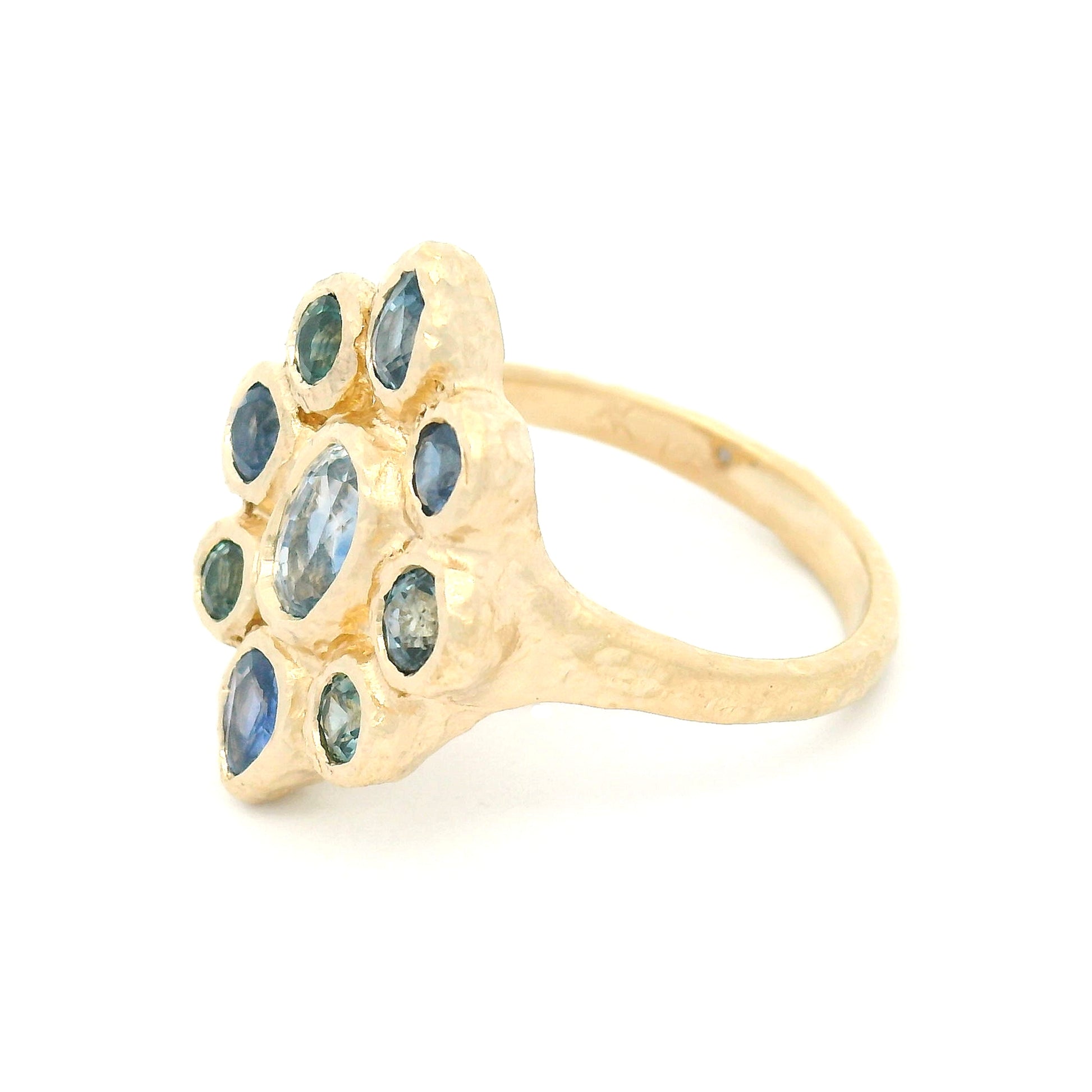14K yellow gold organic cluster engagement ring with natural 0.66ct oval blue sapphire and 1.72cts pear-shaped and round blue sapphire accents.
