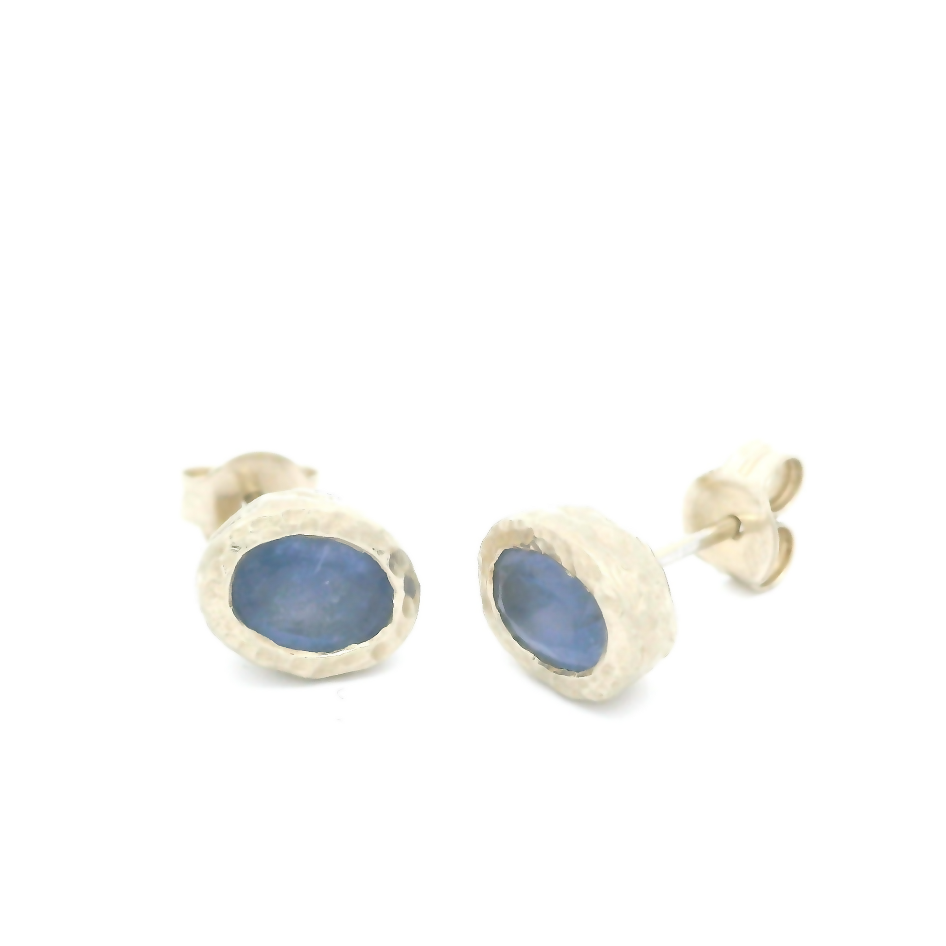 14k white textured organic stud earrings bezel set with oval blue sapphires.