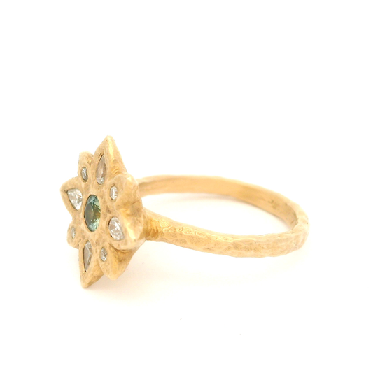 14k yellow organic ring set with a teal blue sapphire and diamond accents.  Shown from the side.