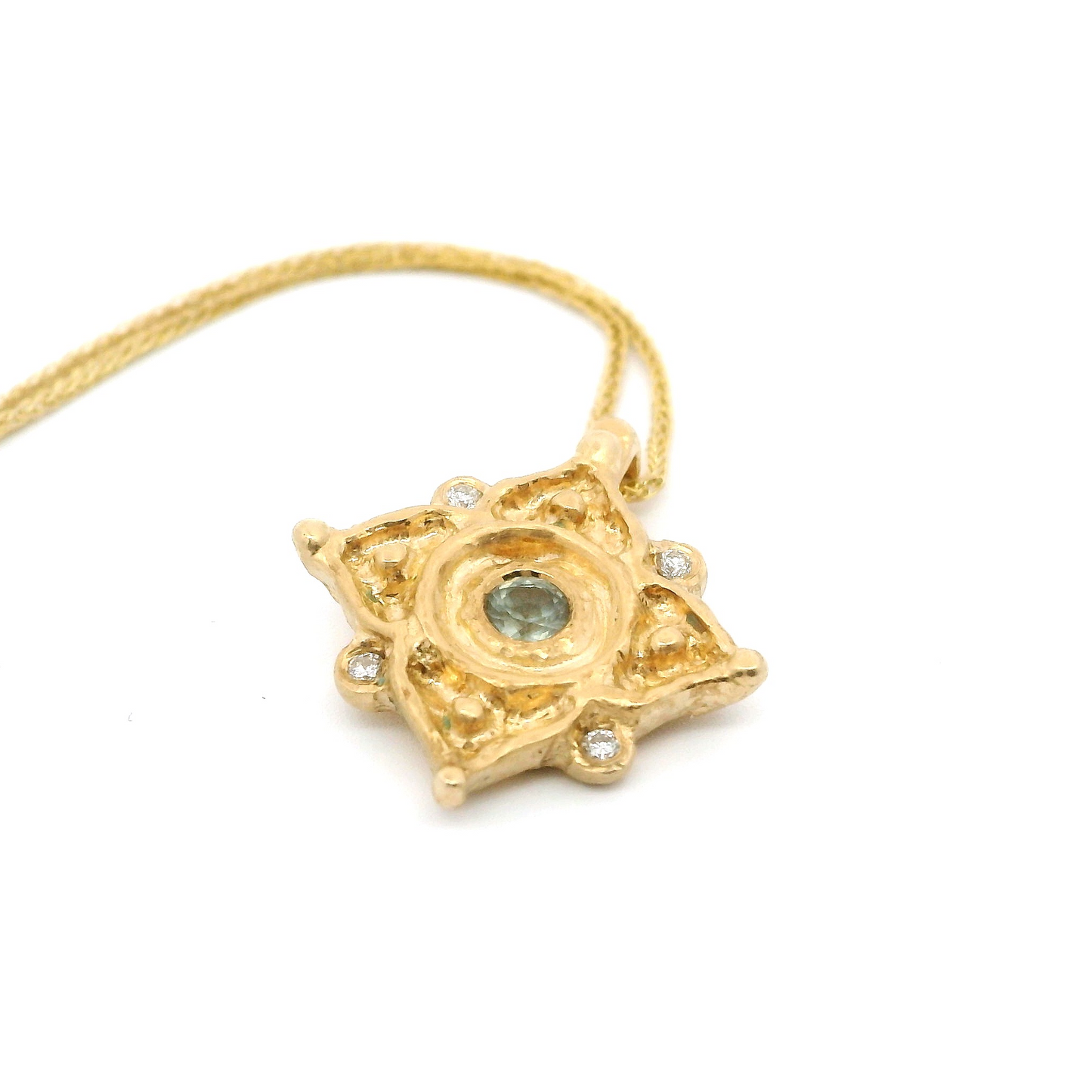 14k yellow organic pendant set with a light teal sapphire and 4 accent diamonds.