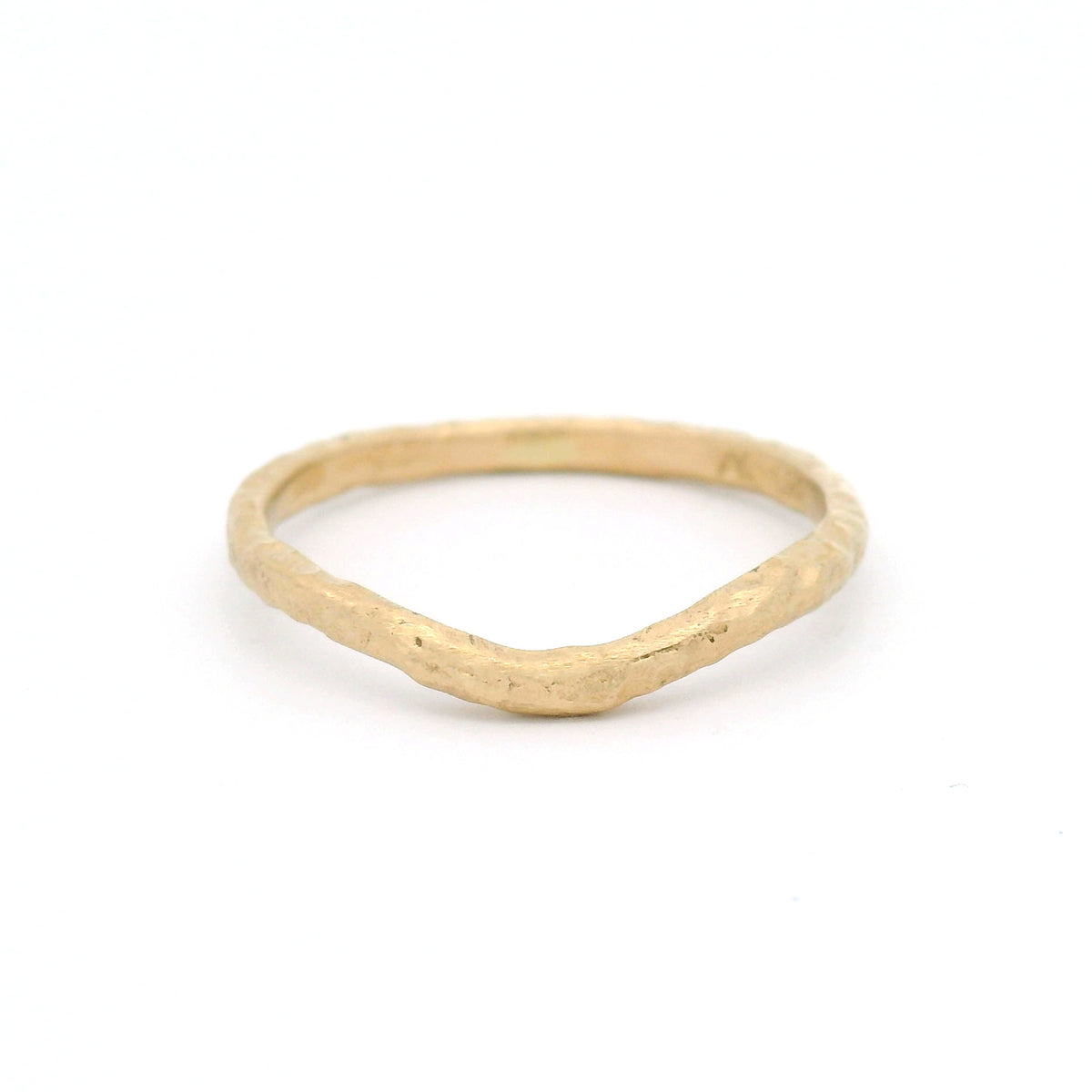 14K yellow gold 1.8mm contoured wedding band with an organic textured surface inspired by weathered sand and gentle waves.