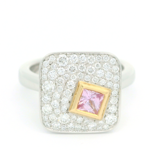 Plat and 18k yellow ring with bezel set 0.25ct pink princess cut sapphire surrounded by pave set diamonds.