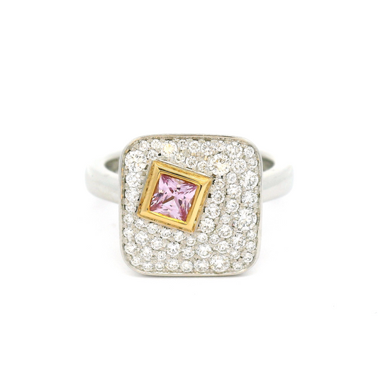 Plat and 18k yellow ring with bezel set 0.25ct pink princess cut sapphire surrounded by pave set diamonds.
