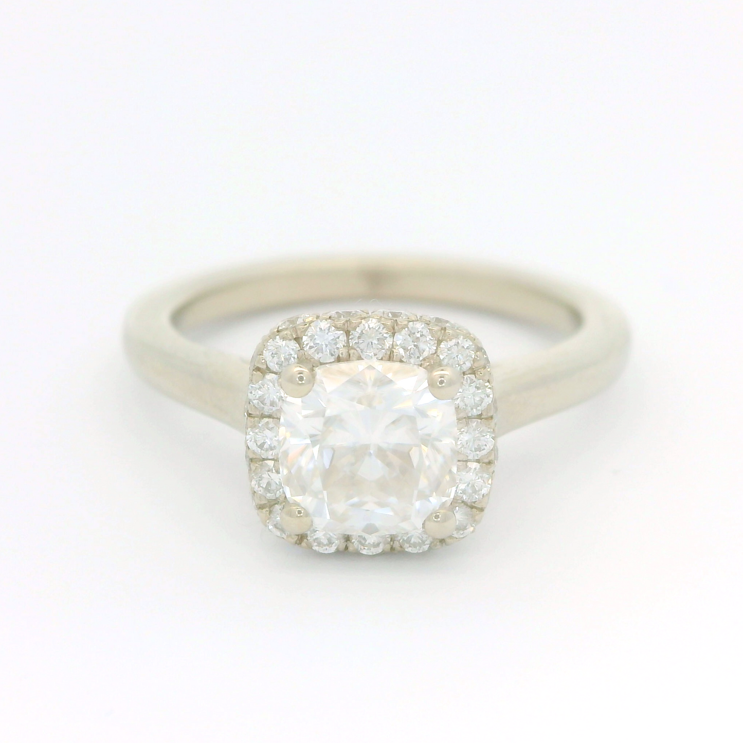14k white ring set with a 1.1ct moissanite and a accent double sided diamond halo.
