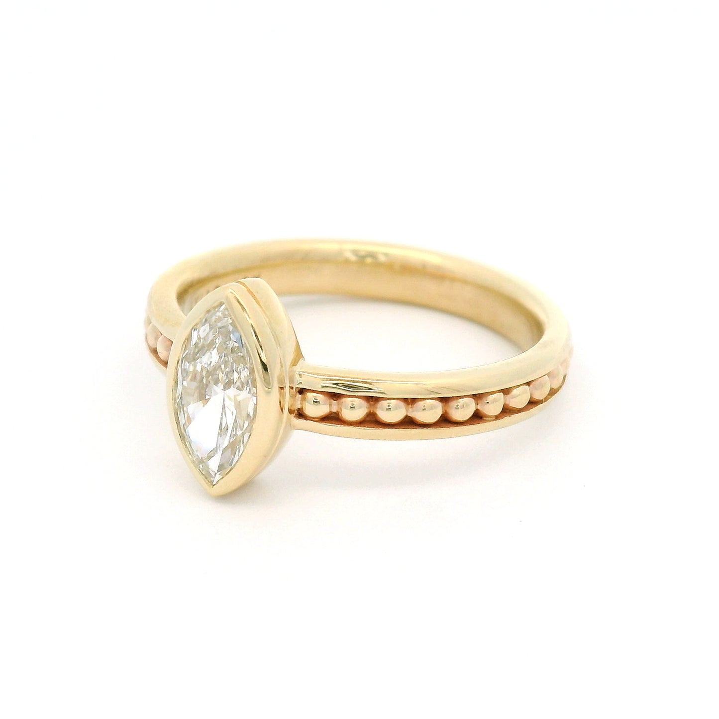 10K yellow gold solitaire engagement ring with a bezel-set 0.70ct lab-grown marquise-cut diamond and delicate gold bead accents within channel details along the band.
