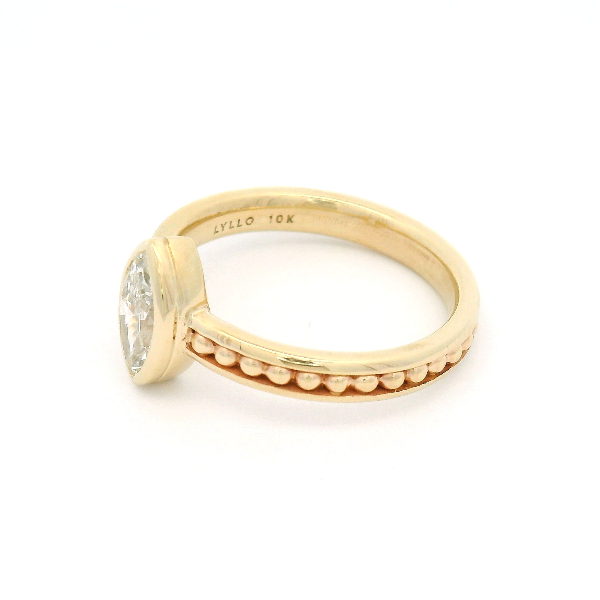 10K yellow gold solitaire engagement ring with a bezel-set 0.70ct lab-grown marquise-cut diamond and delicate gold bead accents within channel details along the band.