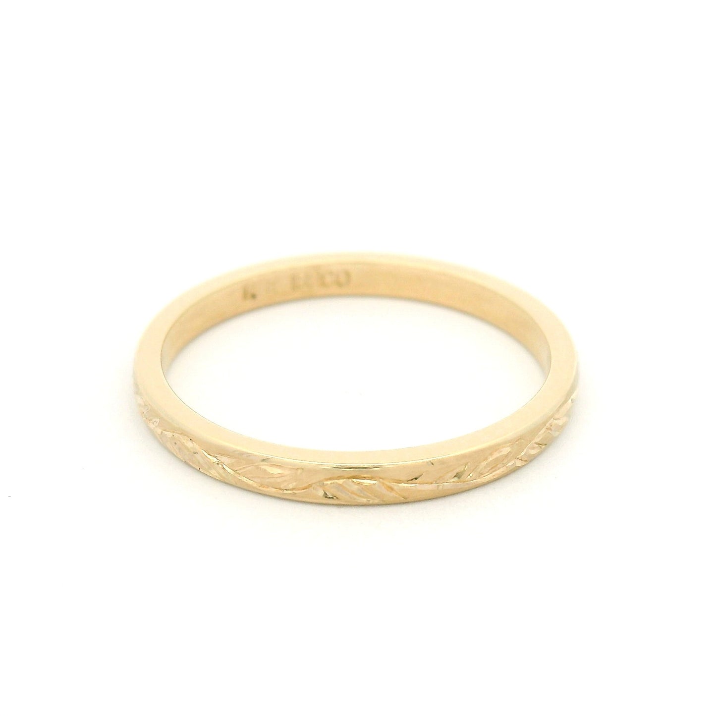 10K yellow gold 2mm flat profile band with hand-engraved vine pattern and detailed nature-inspired design.