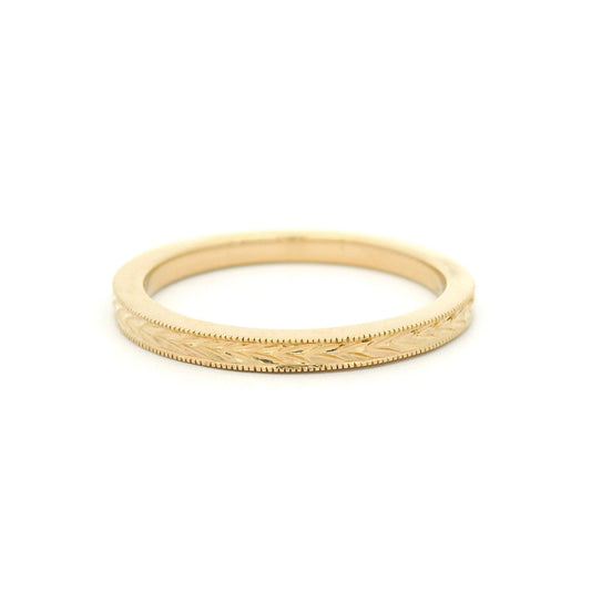 14K yellow gold 2mm flat profile band with hand-engraved wheat sheaf pattern and milgrain edge detailing.