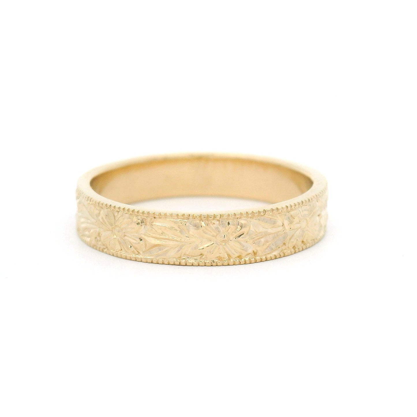 14K yellow gold 4.5mm flat profile band with hand-engraved floral pattern and milgrain edges.