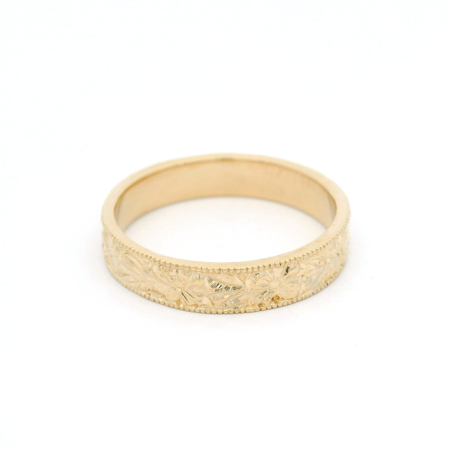 14K yellow gold 4.5mm flat profile band with hand-engraved floral pattern and milgrain edges.